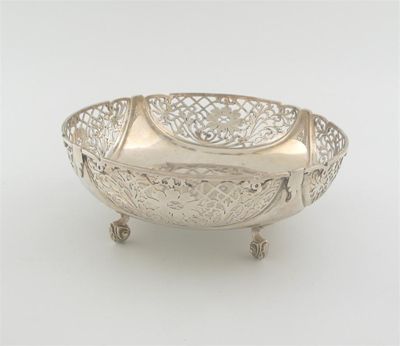 Appraisal: A modern pierced fruit dish on four scroll feet shallow