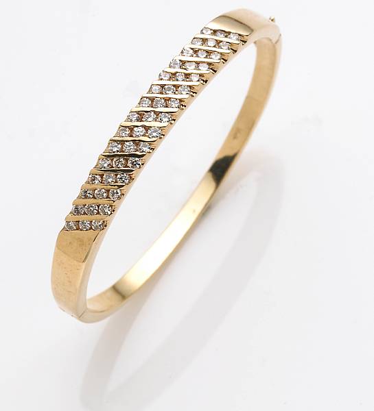 Appraisal: A diamond and k gold bangle bracelet estimated total diamond