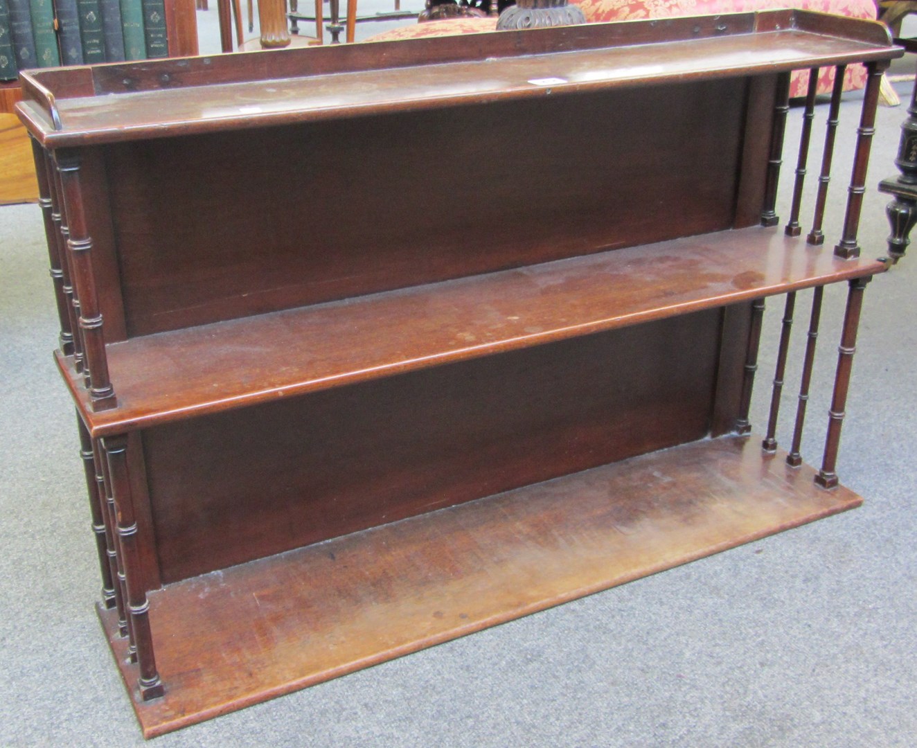 Appraisal: An early th century mahogany three tier hanging shelf with