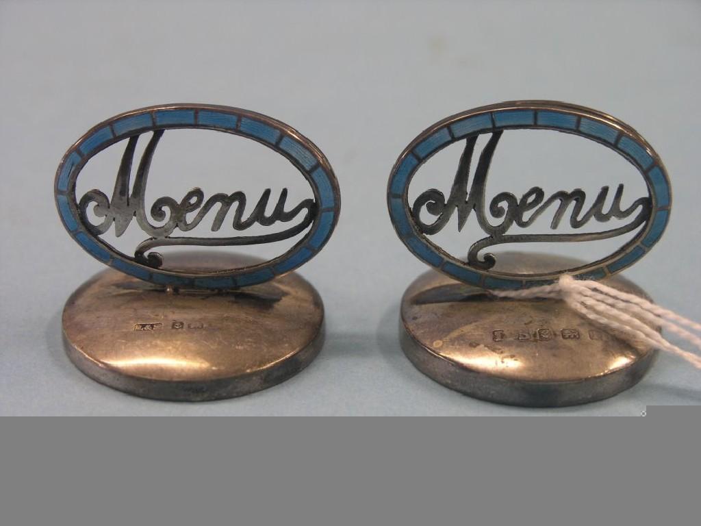 Appraisal: A pair of silver and blue enamel menu holders on