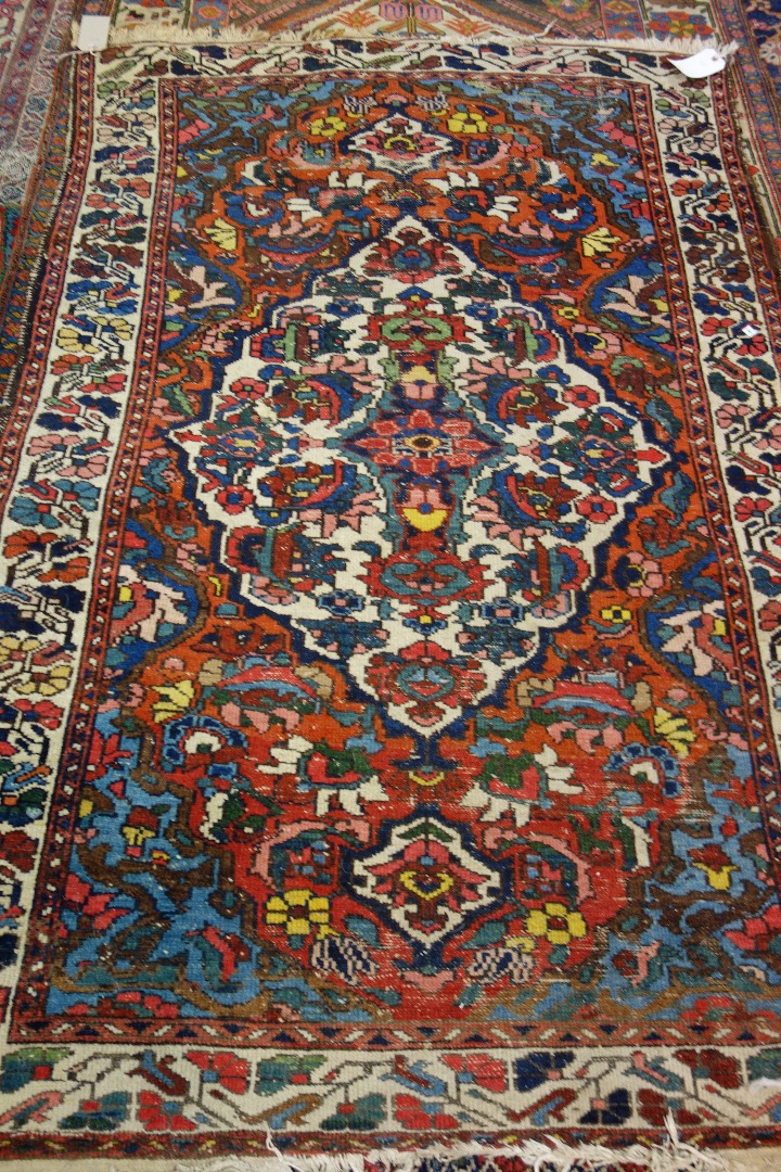 Appraisal: A Bakhtiari rug Persian the madder field with a bold