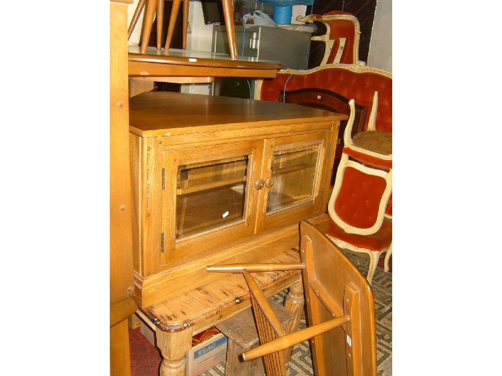 Appraisal: An Ercol elm low corner TV stand cabinet enclosed by