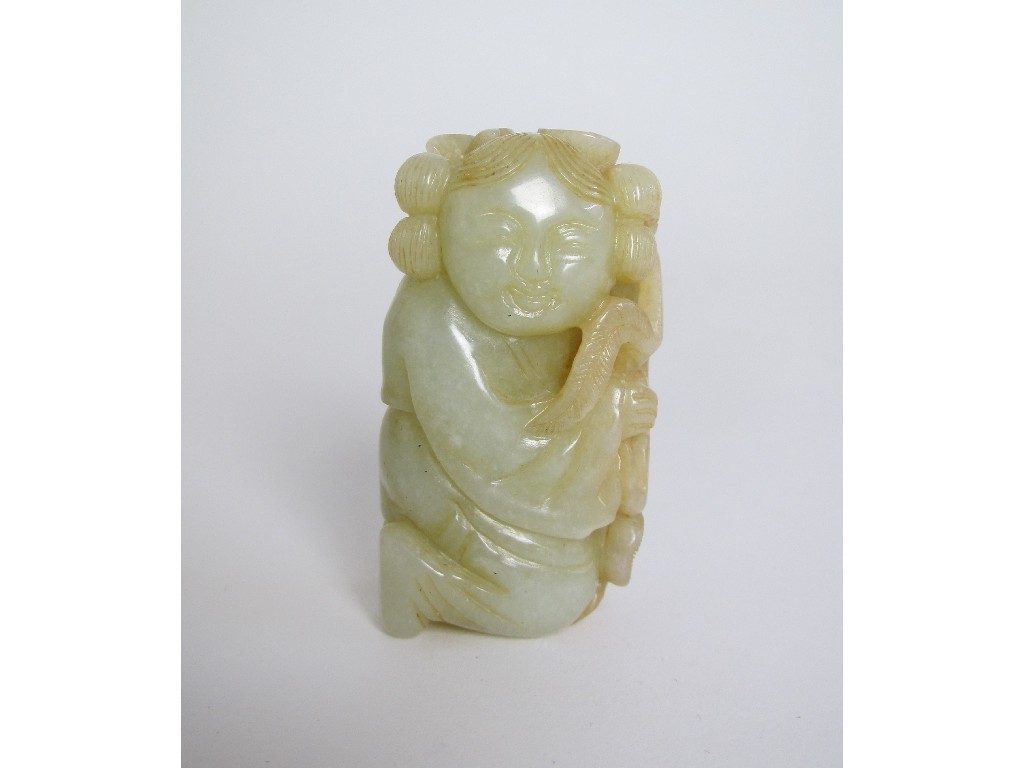 Appraisal: A Chinese jade carving of a young child holding a