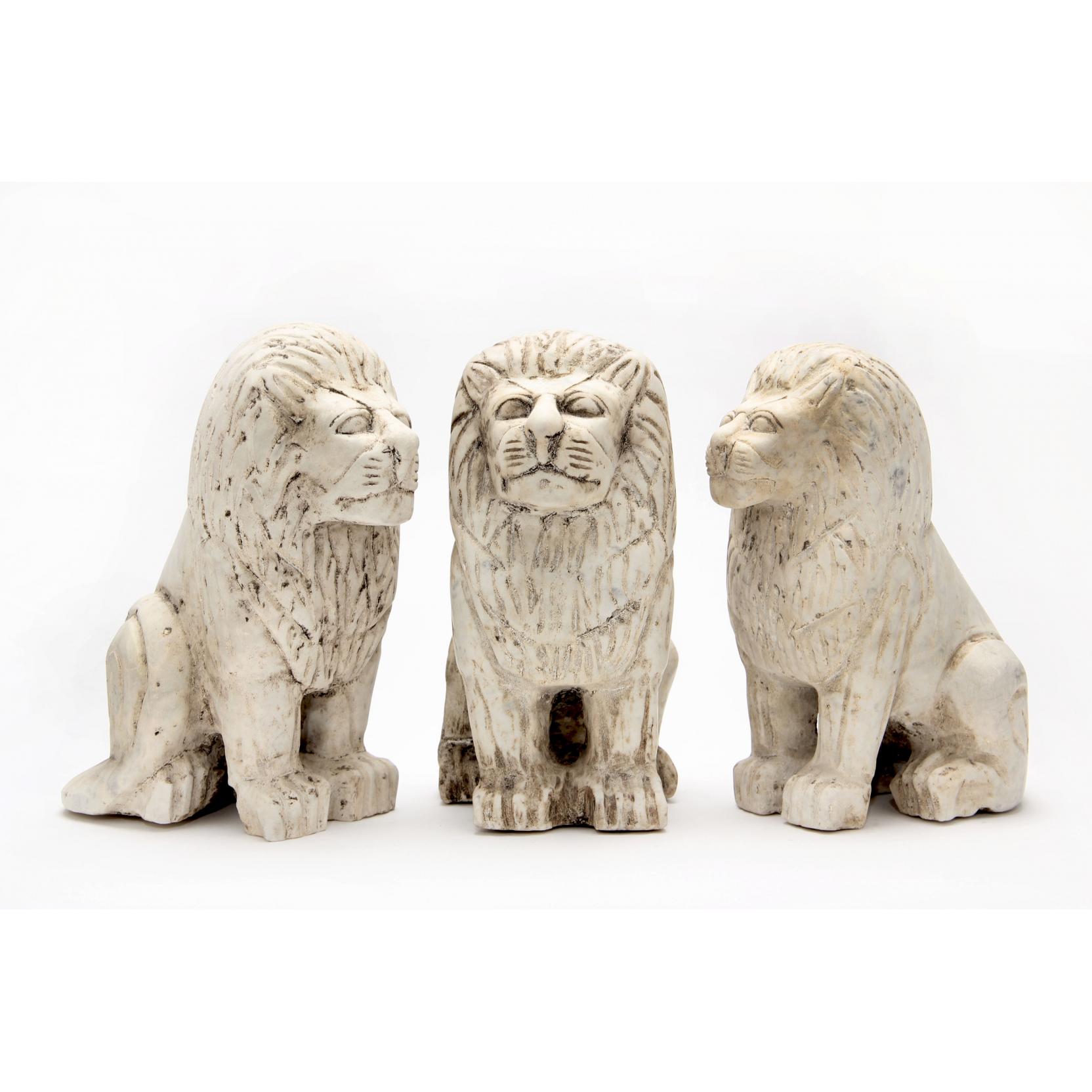 Appraisal: Three Ancient Near Eastern Style Marble Lions seated with schematic