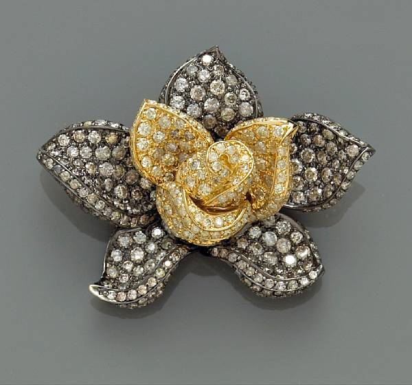 Appraisal: A diamond and colored diamond flower brooch accented with round