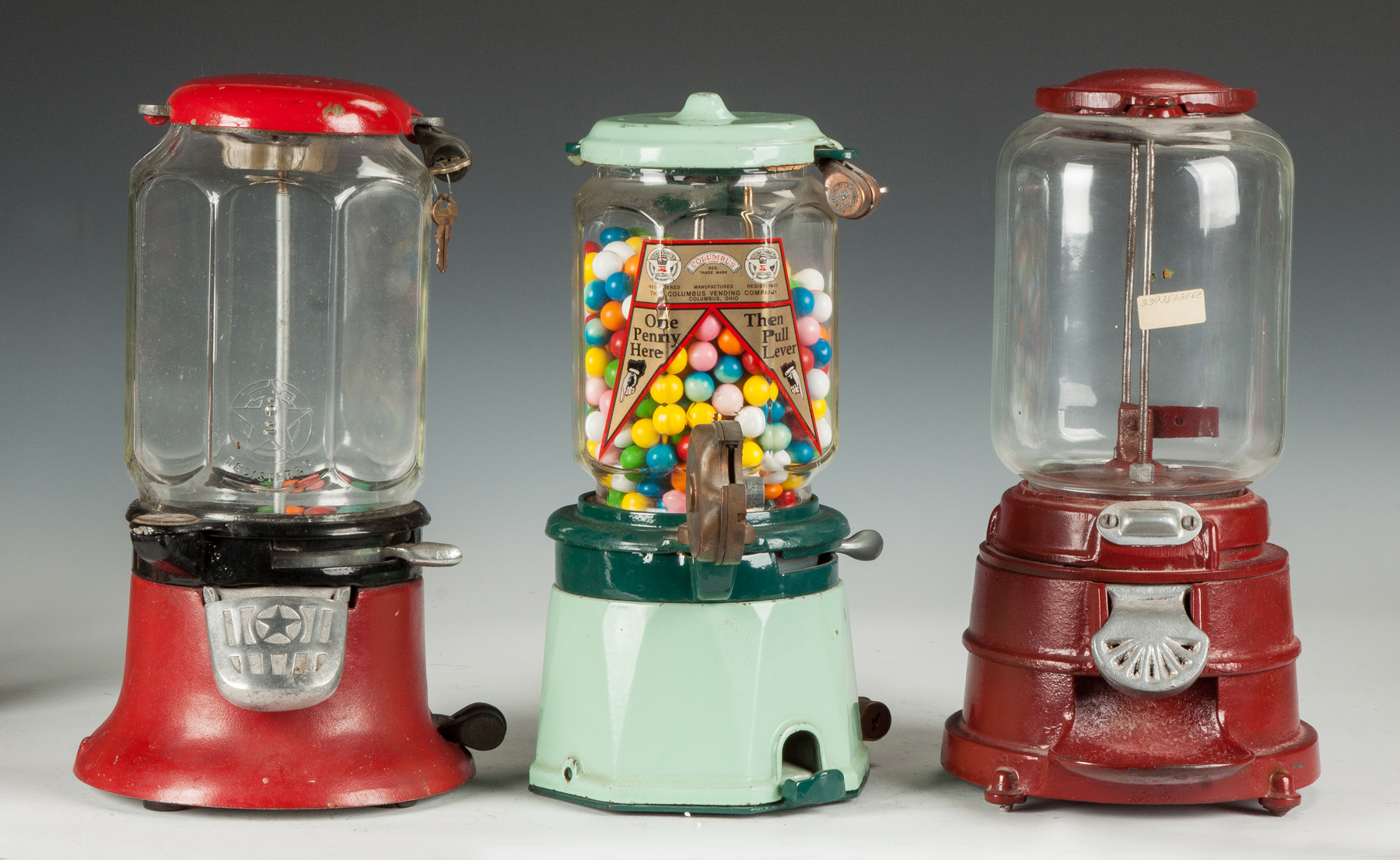 Appraisal: Three Vintage Gumball Machines L to R Red cast aluminum