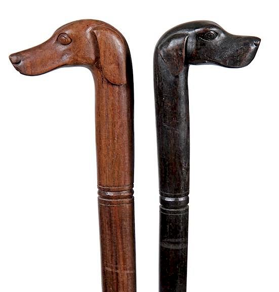 Appraisal: Dog Canes A pair of th Century carvings of two