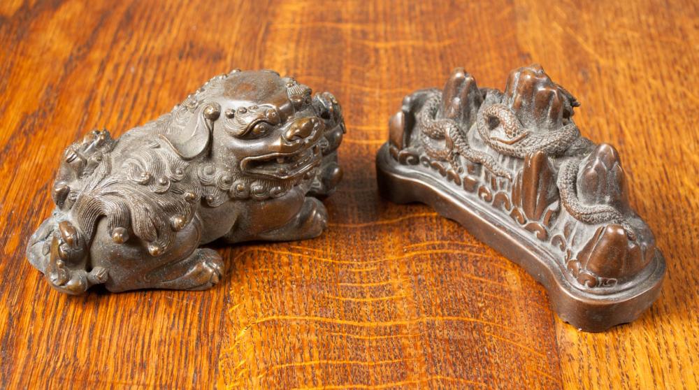 Appraisal: TWO CHINESE BRONZE SCHOLAR'S OBJECTS comprised of the figural paperweight