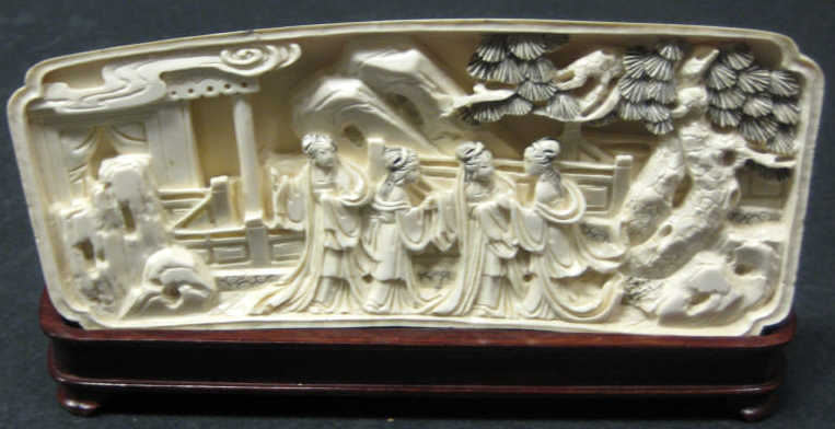 Appraisal: CHINESE CARVED IVORY PLAQUE High relief depicting four ladies on