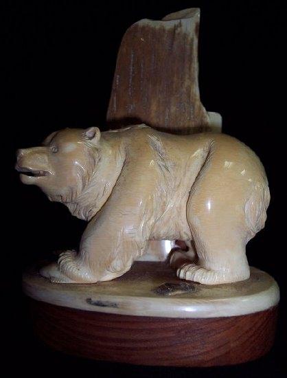 Appraisal: An ivory carving depicting a polar bear with its catch