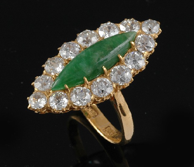 Appraisal: A DIAMOND AND JADEITE PLAQUE RING Centrally set with a