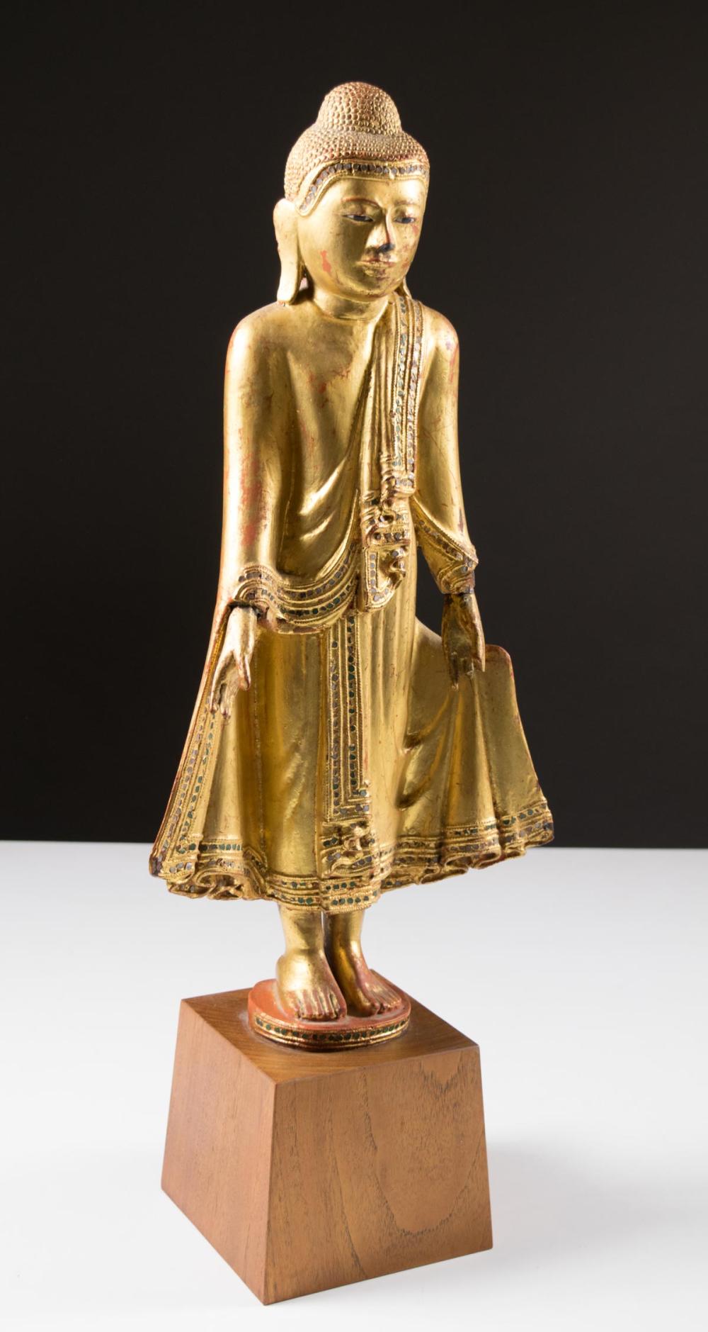 Appraisal: A THAI GILT-WOOD STANDING BUDDHA on walnut plinth his head