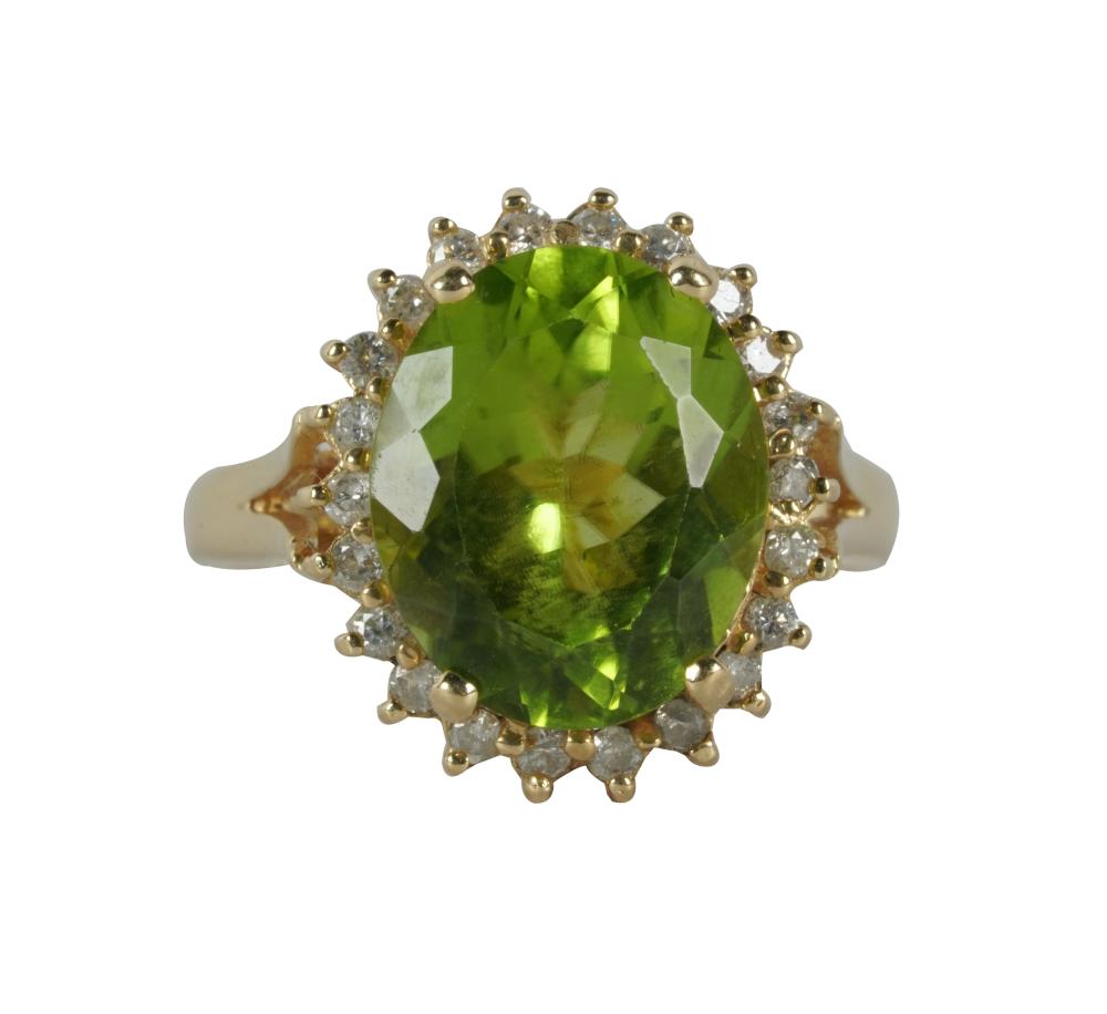 Appraisal: KARAT YELLOW GOLD PERIDOT DIAMOND RINGcentering one oval peridot weighing