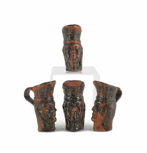 Appraisal: Set of four redware pitchers in the form of Native