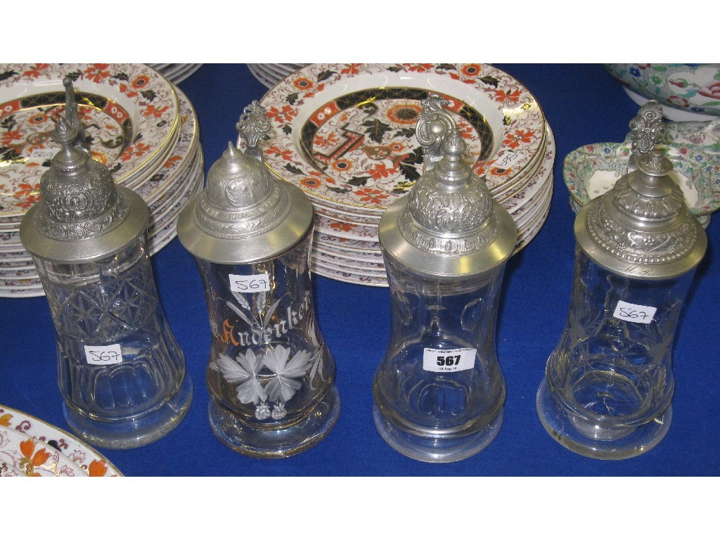 Appraisal: Lot comprising four glass steins with pewter mounts and lids