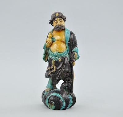 Appraisal: A Chinese Shiwan Immortal Depicting a Taoist Immortal standing on