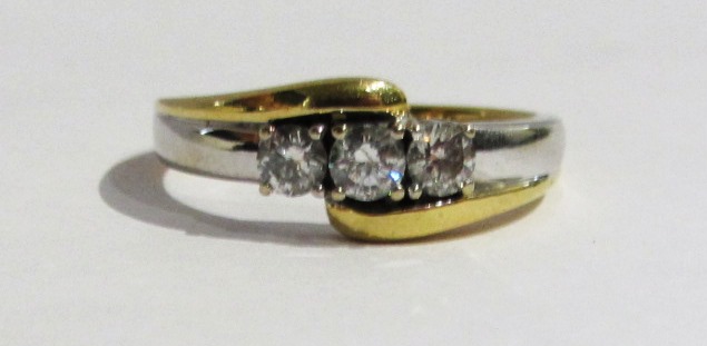 Appraisal: A two colour gold and diamond set three stone ring