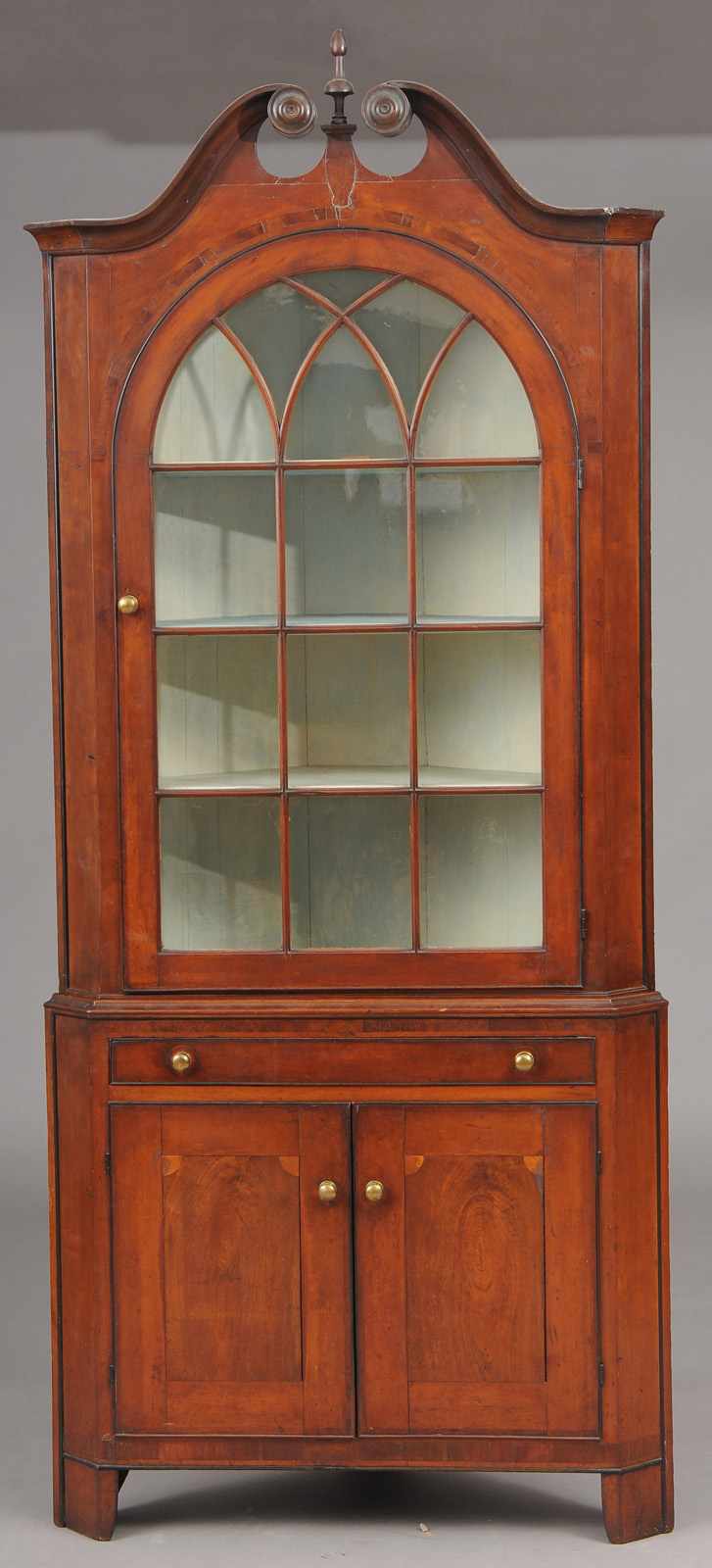 Appraisal: FEDERAL INLAID MAHOGANY CORNER CUPBOARD The swan's neck pediment with