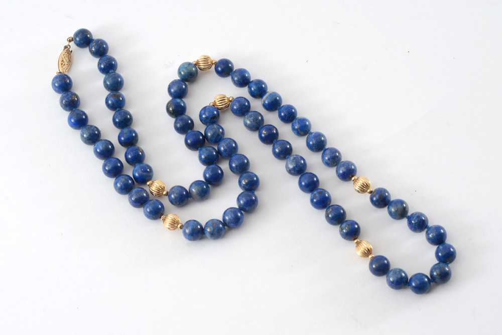 Appraisal: GOLD AND LAPIS BEAD NECKLACE A '' continuous strand of