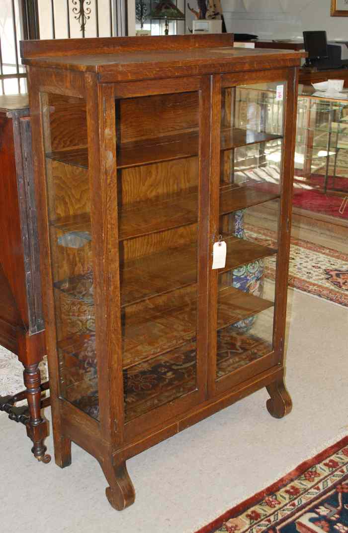 Appraisal: OAK CHINA CABINET Empire Revival design American c having four