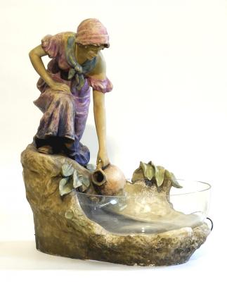 Appraisal: A GOLDSCHEIDER POTTERY LAMP modelled as a maiden wearing purple