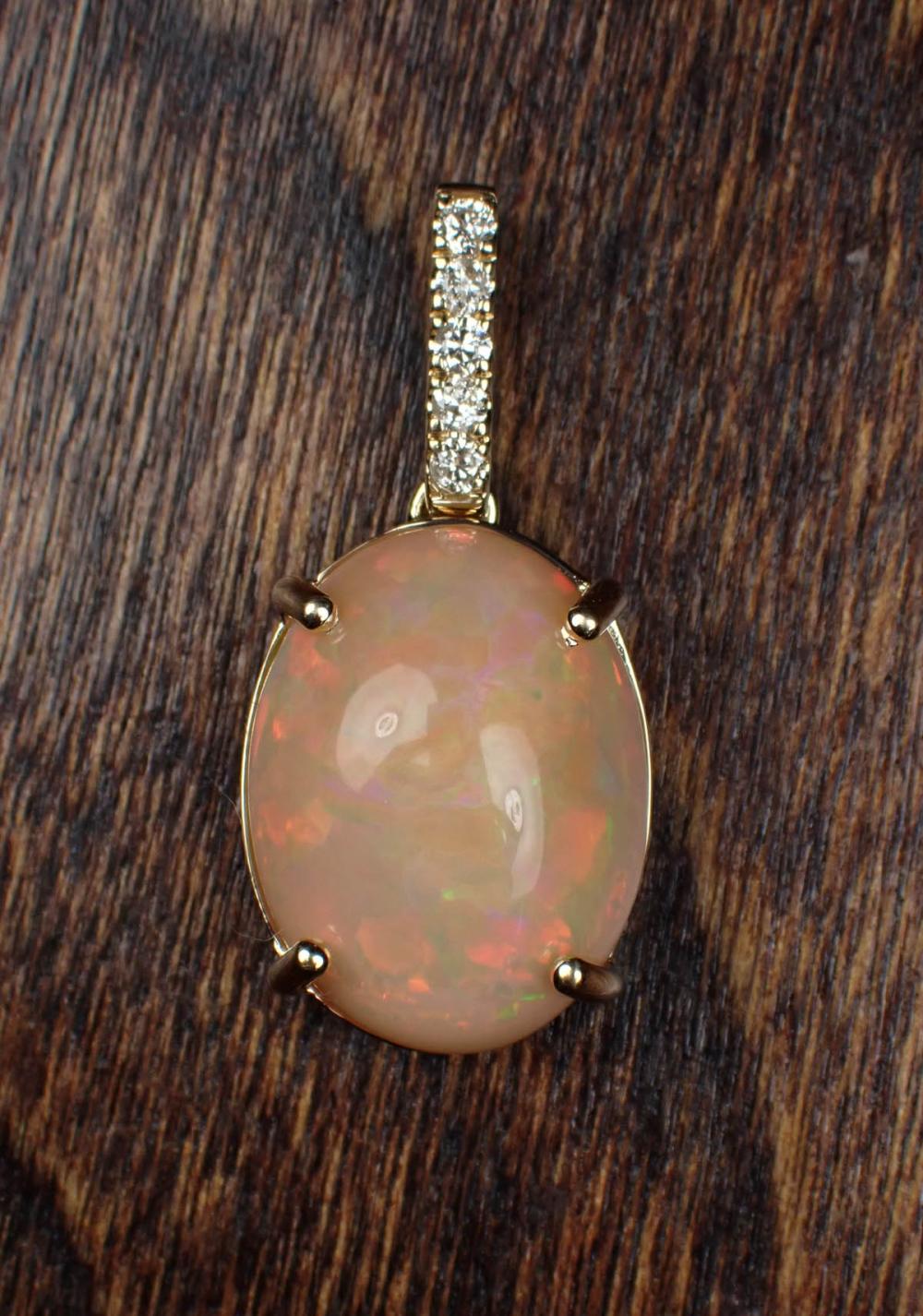 Appraisal: ETHIOPIAN OPAL DIAMOND AND FOURTEEN KARAT GOLD PENDANT The yellow