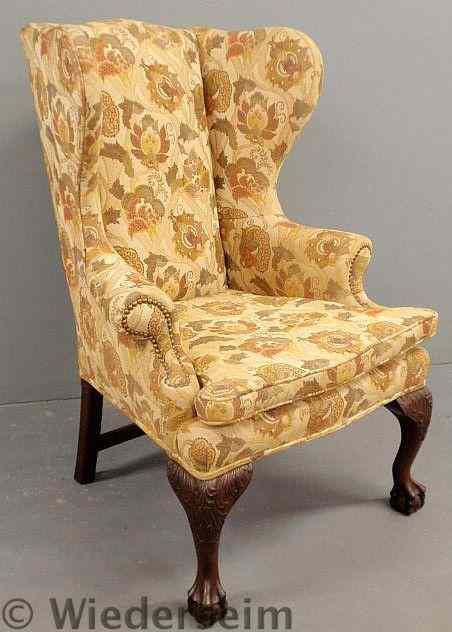 Appraisal: Chippendale style mahogany wing chair with floral upholstery acanthus carved