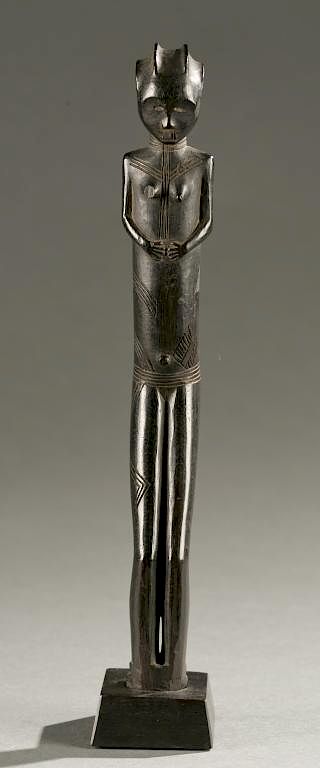 Appraisal: Tanzanian standing female figure A standing female figure bent slightly