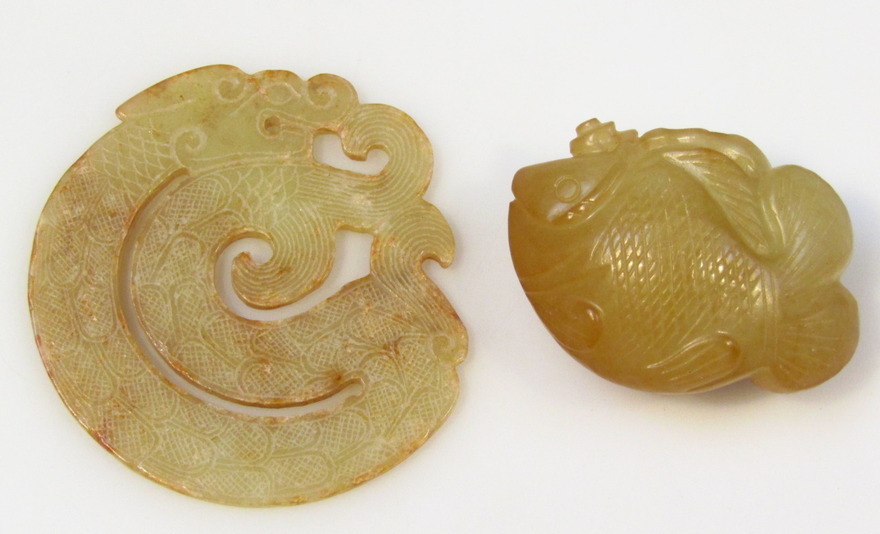 Appraisal: A heavily carved green jade fish of shaped outline probably