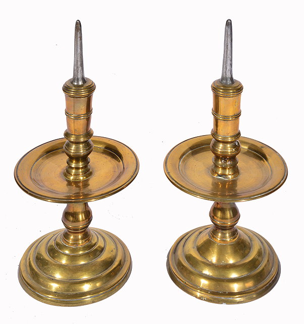 Appraisal: A PAIR OF ANTIQUE TURNED BRASS PRICKET CANDLESTICKS with drip