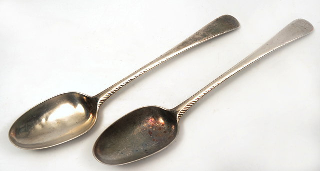 Appraisal: A PAIR OF GEORGE III SILVER TABLE SPOONS with feather