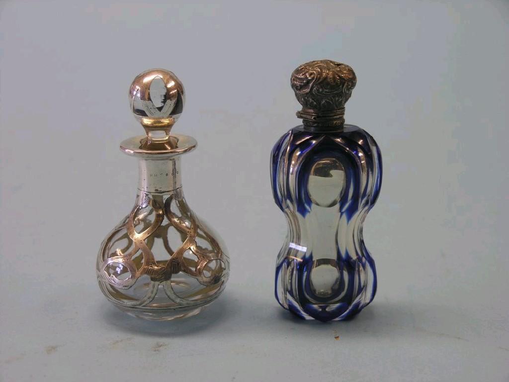 Appraisal: A Victorian blue-overlaid glass scent bottle with stopper and silver