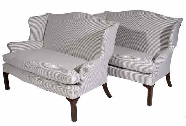 Appraisal: A PAIR OF GEORGIAN STYLE WING BACK TWO SEATER SOFAS