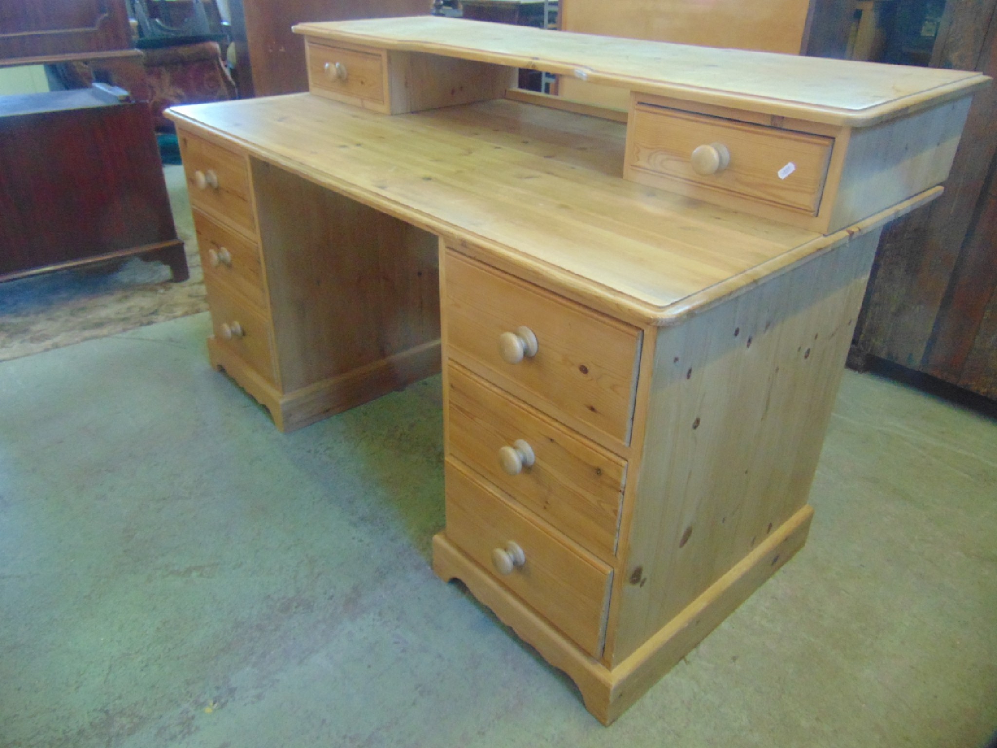 Appraisal: A contemporary stripped pine kneehole twin pedestal desk each pedestal