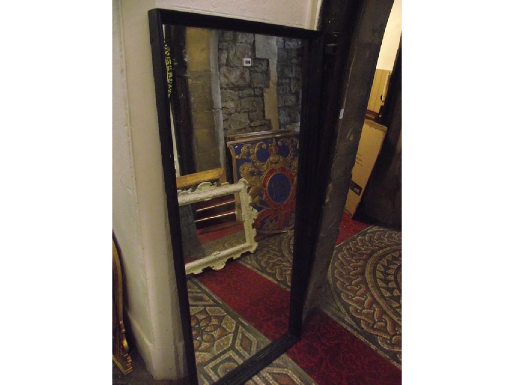 Appraisal: A full length dressing mirror with simple ebonised rectangular moulded