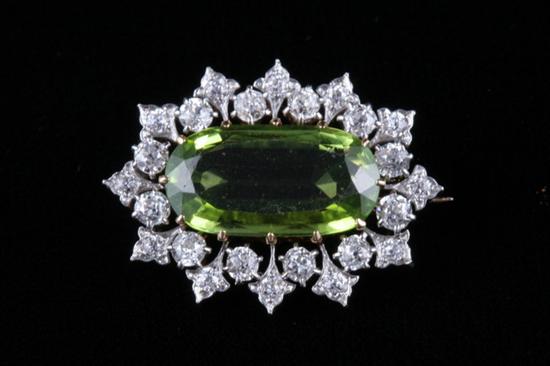 Appraisal: EDWARDIAN PLATINUM-ON-YELLOW GOLD DIAMOND AND PERIDOT PIN Fancy-cut oval peridot