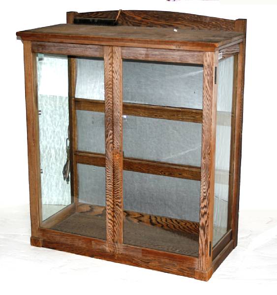 Appraisal: A Japanese mixed wood and glass commercial display cabinet Fronted