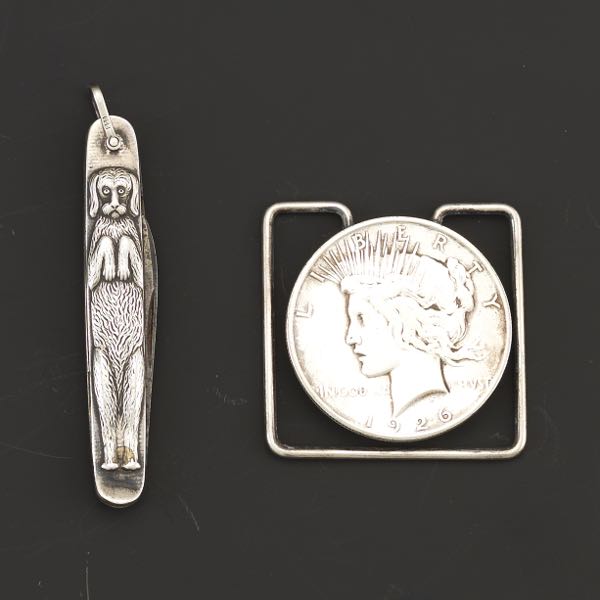 Appraisal: LIBERTY SILVER DOLLAR MONEY CLIP AND CANINE SILVER POCKET KNIFE