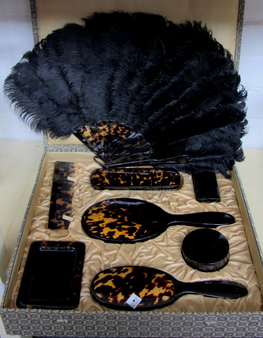 Appraisal: A faux tortoiseshell dressing table set boxed and an ostrich