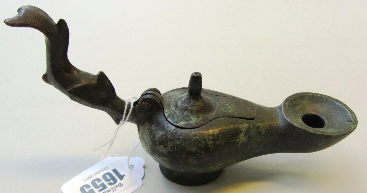 Appraisal: A Roman bronze lamp with dolphin handle fitted lid and