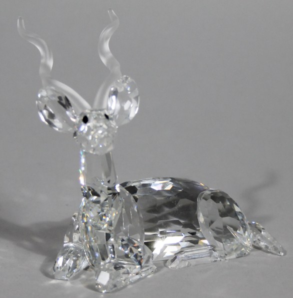 Appraisal: A Swarovski crystal figure of a recumbent stag cm wide