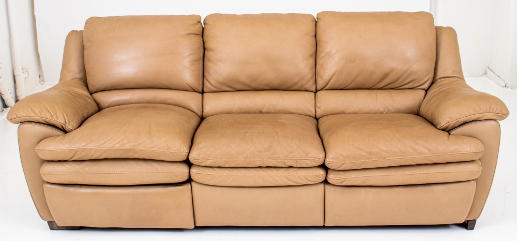 Appraisal: MODERN CREAM-COLORED LEATHER RECLINING SOFA Of typical form with upholstered