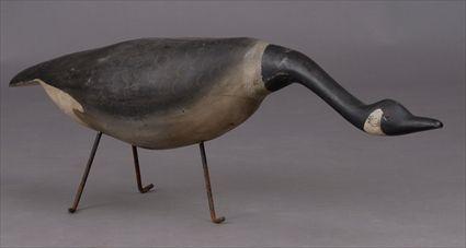 Appraisal: CARVED WOOD MODEL OF A CANADA GOOSE On wrought iron