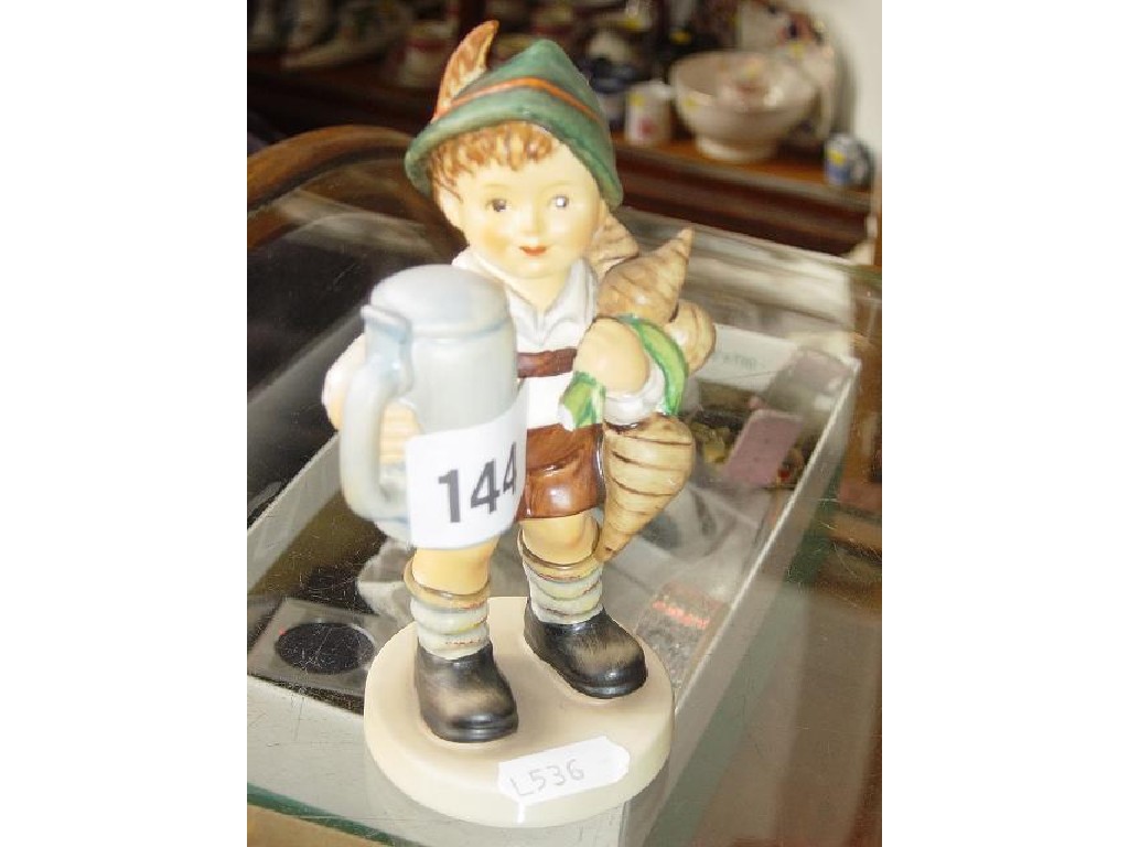 Appraisal: A Hummel figure of a little boy holding a bunch