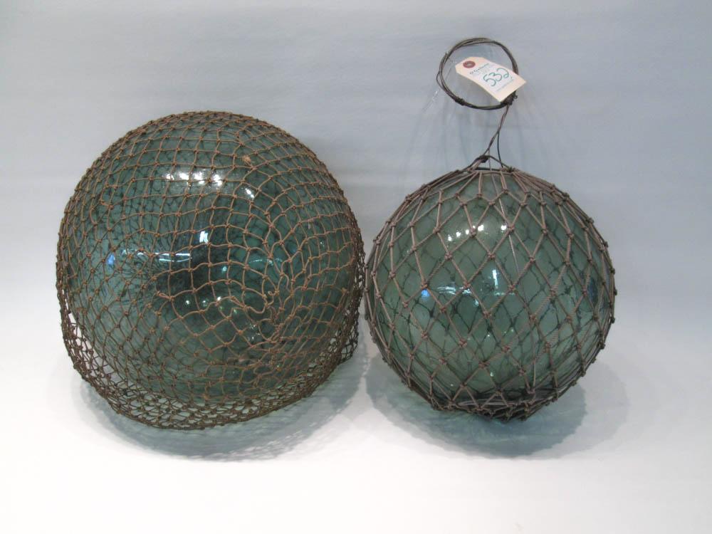 Appraisal: TWO JAPANESE GLASS FISHING FLOATS with original nets Circumference to