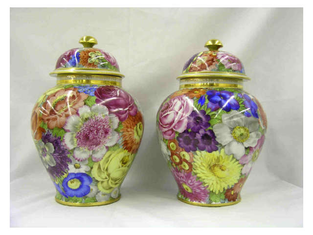 Appraisal: Pair of hand painted multi-colored floral motif Dresden lidded ginger