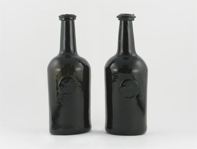 Appraisal: A pair of dated wine bottles each applied with a