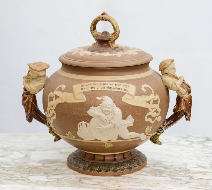 Appraisal: METTLACH FIGURAL HANDLE PUNCH BOWL Lid with foliate scroll handles