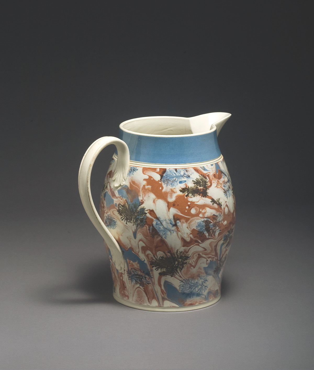 Appraisal: BRITISH CREAMWARE MOCHAWARE JUG CIRCA Of ovoid form slip-marbled in