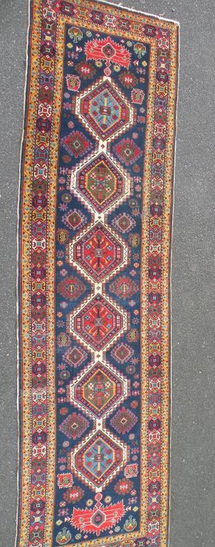 Appraisal: A Persian type runner with a design of medallions on